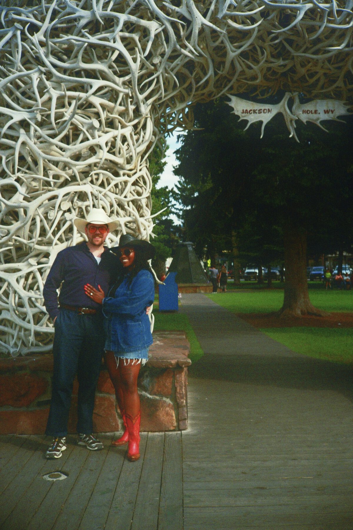 Robin and Pierce beneath the antler arch on Jackson town square