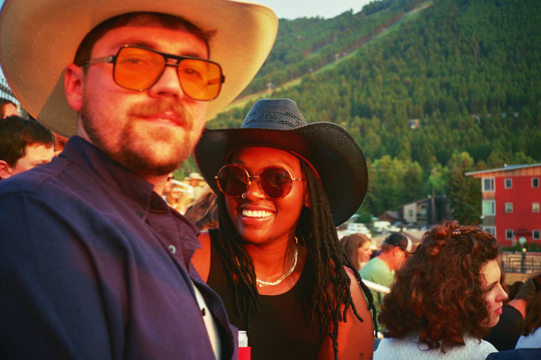 Robin and Pierce close up in warm evening light, hats and sunglasses