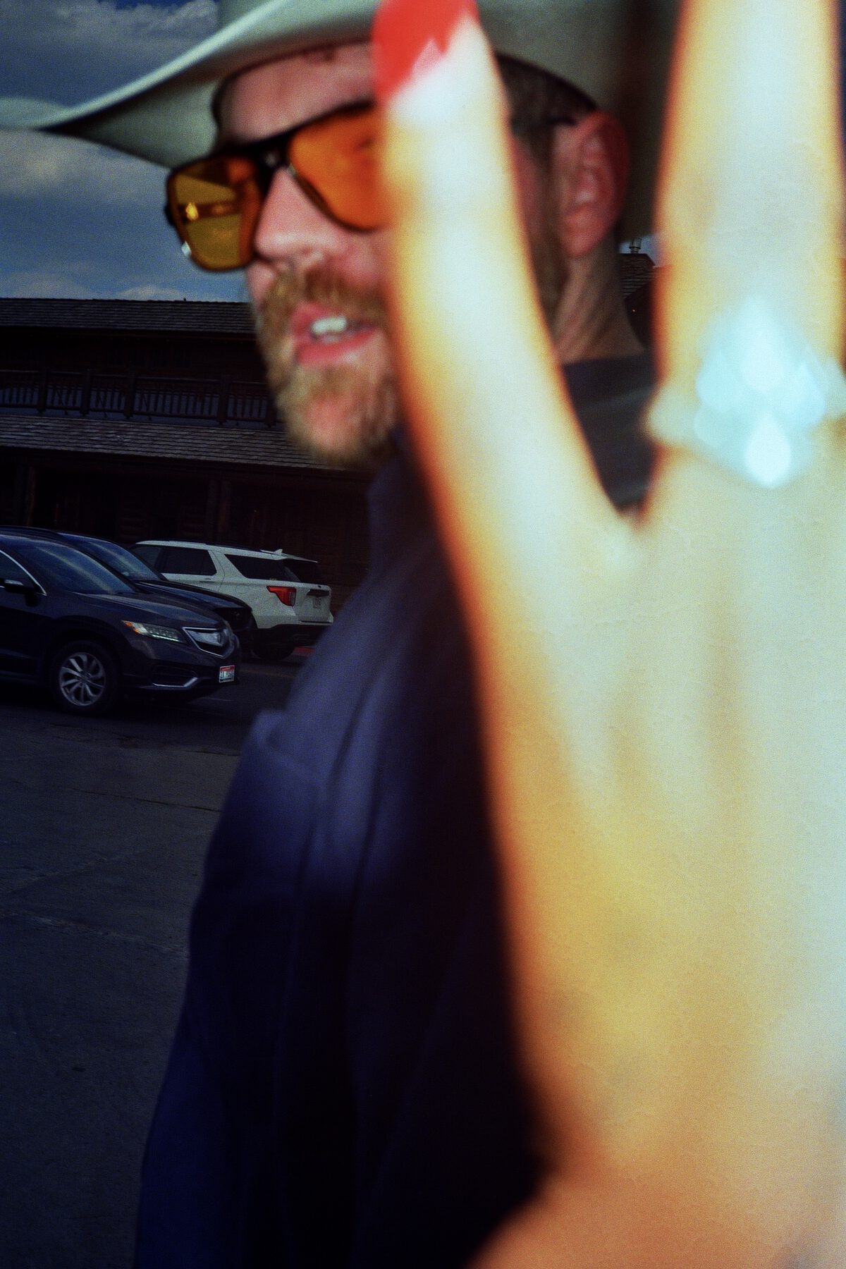 A hand raised toward the camera, ring catching the light