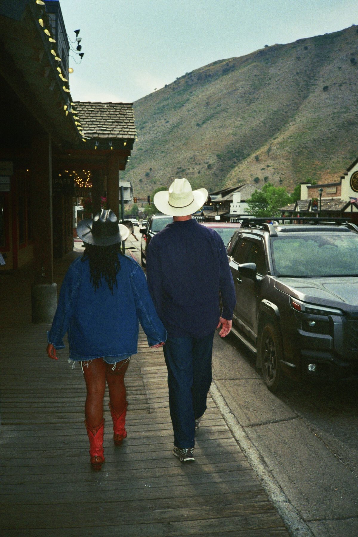 Robin and Pierce walking away down a boardwalk toward the mountains